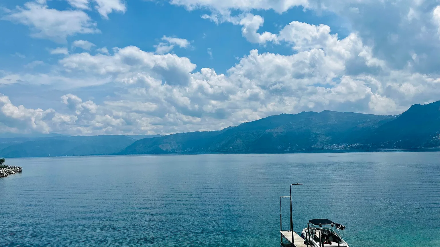 Lake Atitlán beneath volcanic highlands and a cloud-filled sky, Guatemala