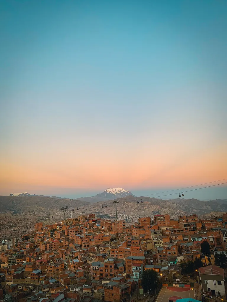La Paz climbing through the Andes beneath Illimani at sunset, Bolivia