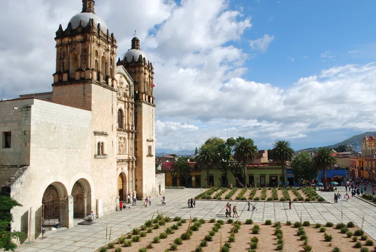 Santo Domingo church and its plaza beneath the mountains in Oaxaca, Mexico