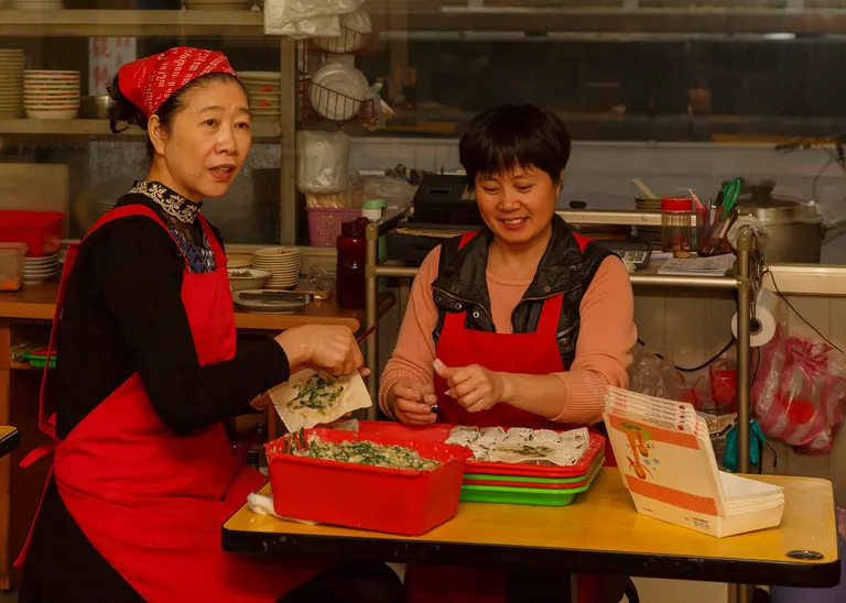 Two cooks preparing food at a Taipei restaurant in Taiwan